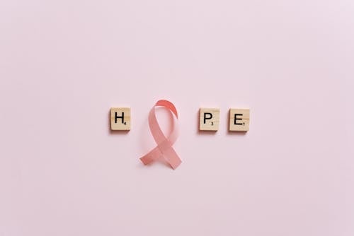 A Pink Ribbon on a Pink Surface with Message