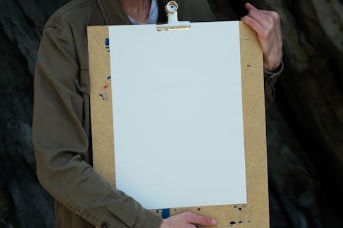 A Person Holding White Printer Paper