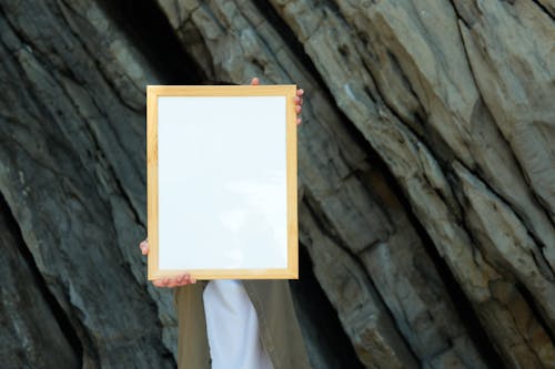 A Person Holding a Blank Wooden Frame