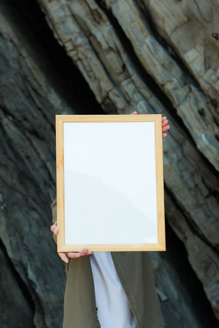  A Person Holding A Blank Wooden Frame