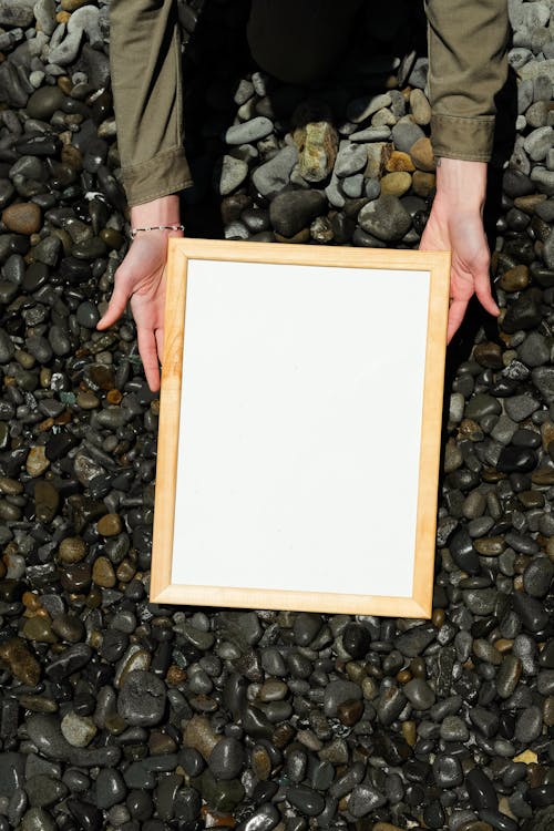 A Person Holding White Blank Paper