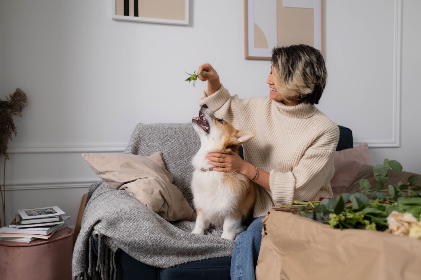 Woman sharing a relaxed, affectionate moment with her dog on a couch in a welcoming home