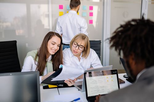 Free Colleagues engaged in a productive meeting in a modern office setting. Stock Photo