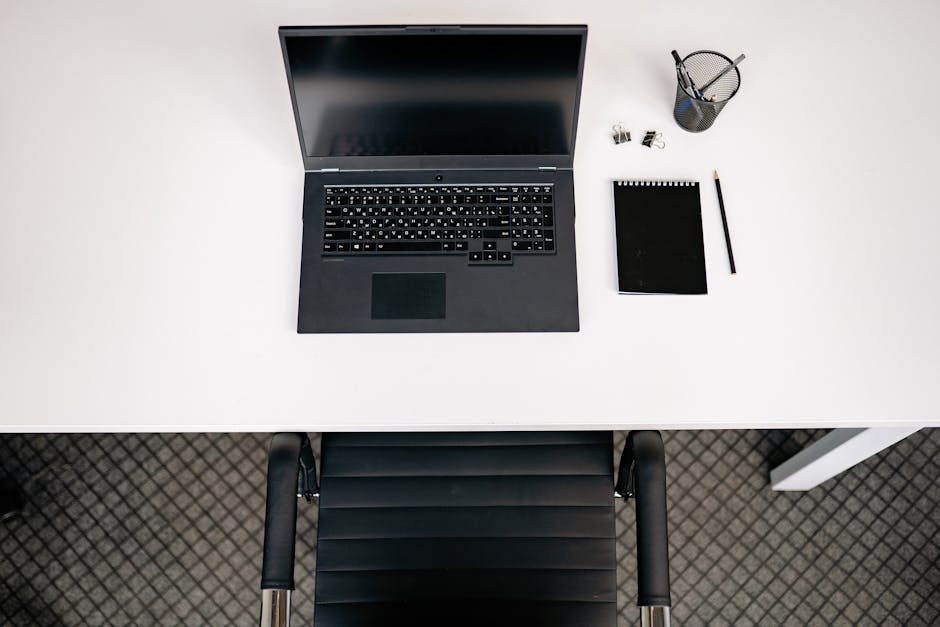 What Sleep Research Reveals About Weighted Blanket Size Top view of a minimalist office desk setup with laptop, notepad, and stationery.