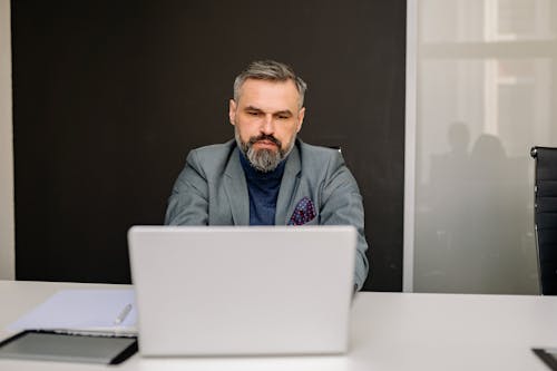 Business Man in Formal Attire using a Laptop 