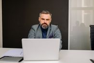 Business Man in Formal Attire using a Laptop