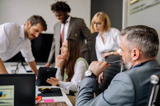 A diverse group of professionals engaging in a collaborative meeting in a modern office setting.