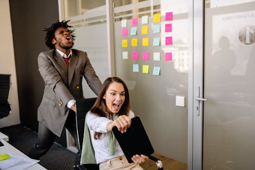 Colleagues enjoying a playful moment in the office, boosting team spirit.