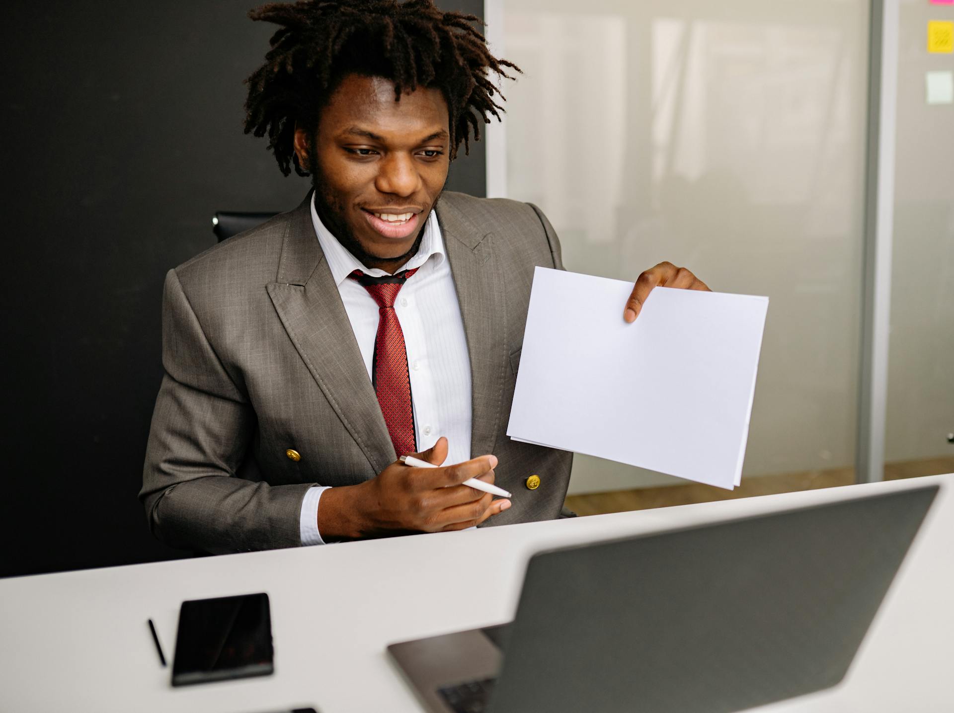 A Man Holding Sheets of Paper