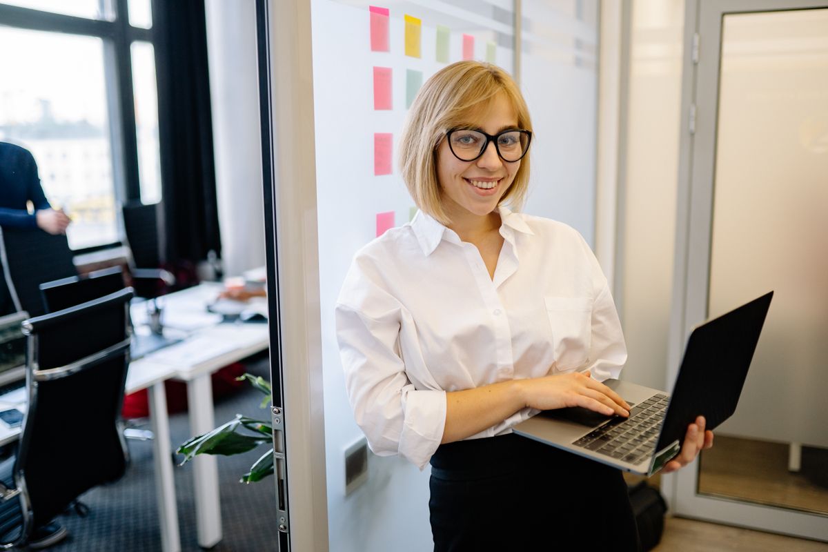 Young woman in glasses smiling confidently