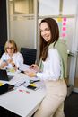 Woman in White long Sleeves Holding a Notepad