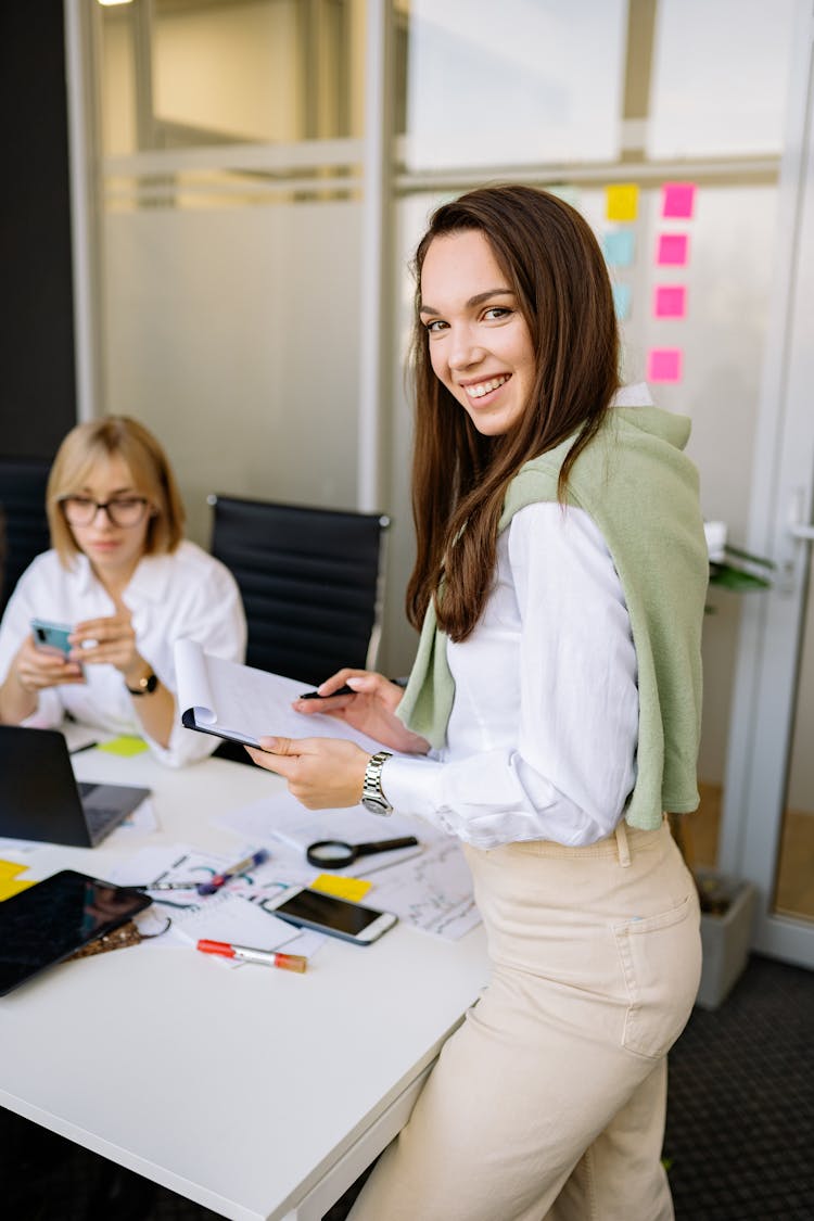 Woman In White Long Sleeves Holding A Notepad