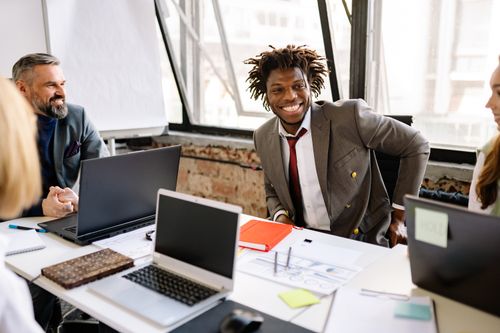 Free Team of diverse professionals meeting in modern office setting. Stock Photo