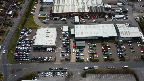 Free Drone shot capturing an industrial area with parking lots and buildings in Luton, England. Stock Photo