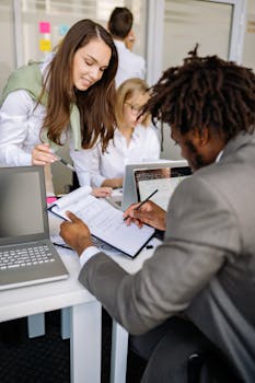 Diverse team working together in an office, sharing ideas and technology for effective collaboration.