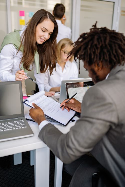 Free Diverse team working together in an office, sharing ideas and technology for effective collaboration. Stock Photo