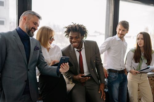 Free Multicultural team enjoying a light moment and collaboration in the office. Stock Photo