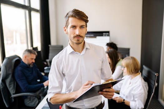 Focused businessman working with team in a modern office setting.