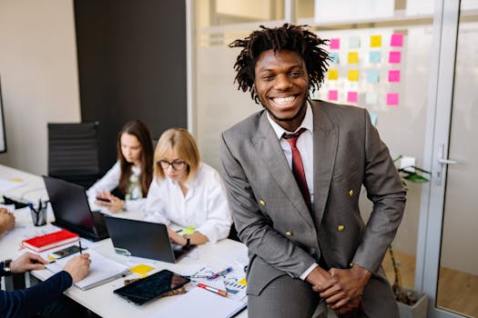Happy colleagues working together in a modern office setting, showcasing diversity.