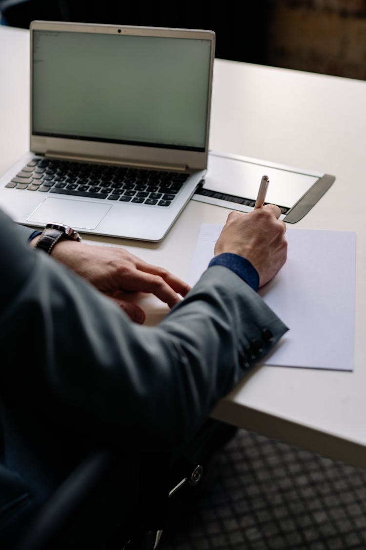 Person Writing On A White Paper 