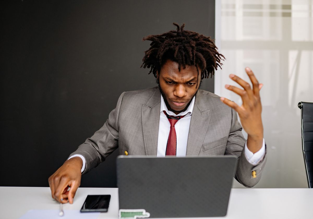 Someone frustrated by a website on their laptop