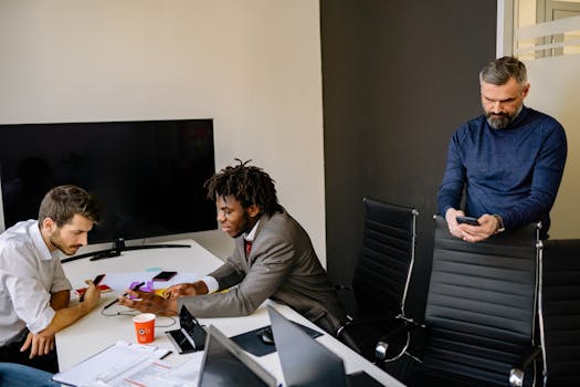 Business colleagues discussing projects around a conference table in a modern office.