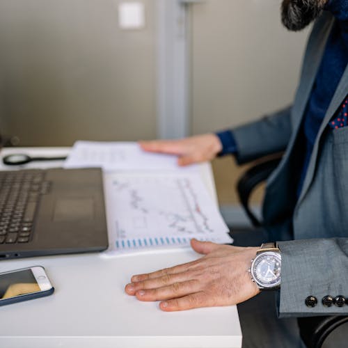 A Person's Hands on His Desk