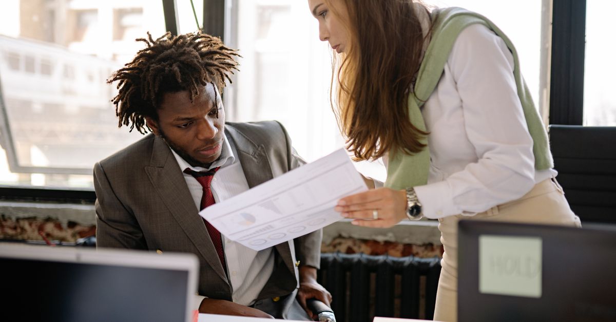 Workplace discussion between colleagues in an office