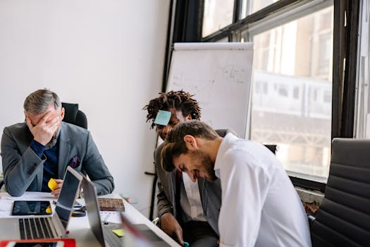 Business team sharing a light moment during a meeting with creativity and laughter.