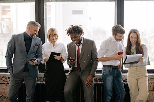 Diverse team of professionals collaborating and smiling in a modern office setting.