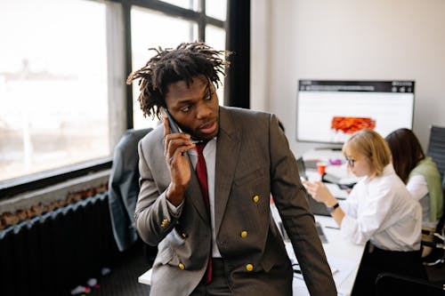 A Man in Brown Suit Having a Phone Call