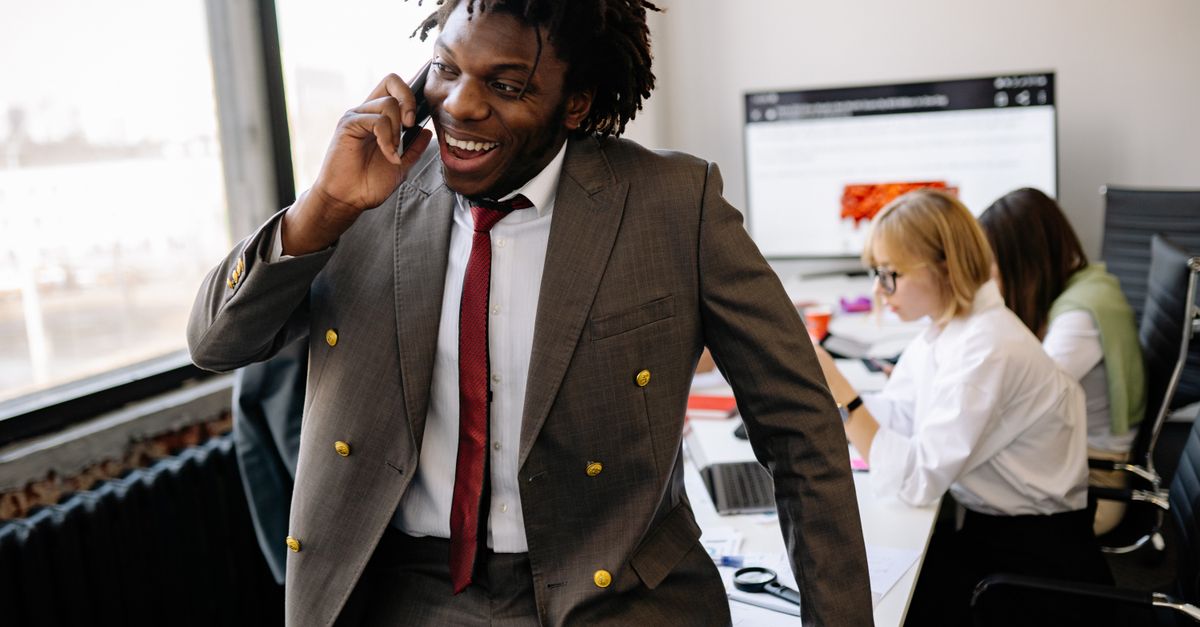 team leader texting on phone in office