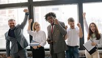 Team celebrating with raised fists in a bright office — photo by Yan Krukau on Pexels