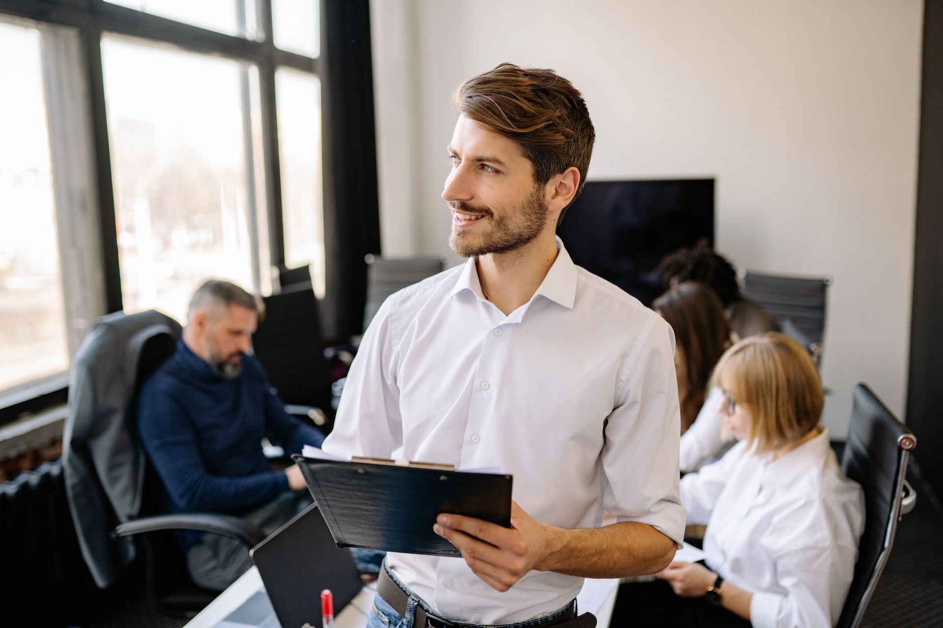 A Bearded Man in White Dress Shirt Holding a Clipboard