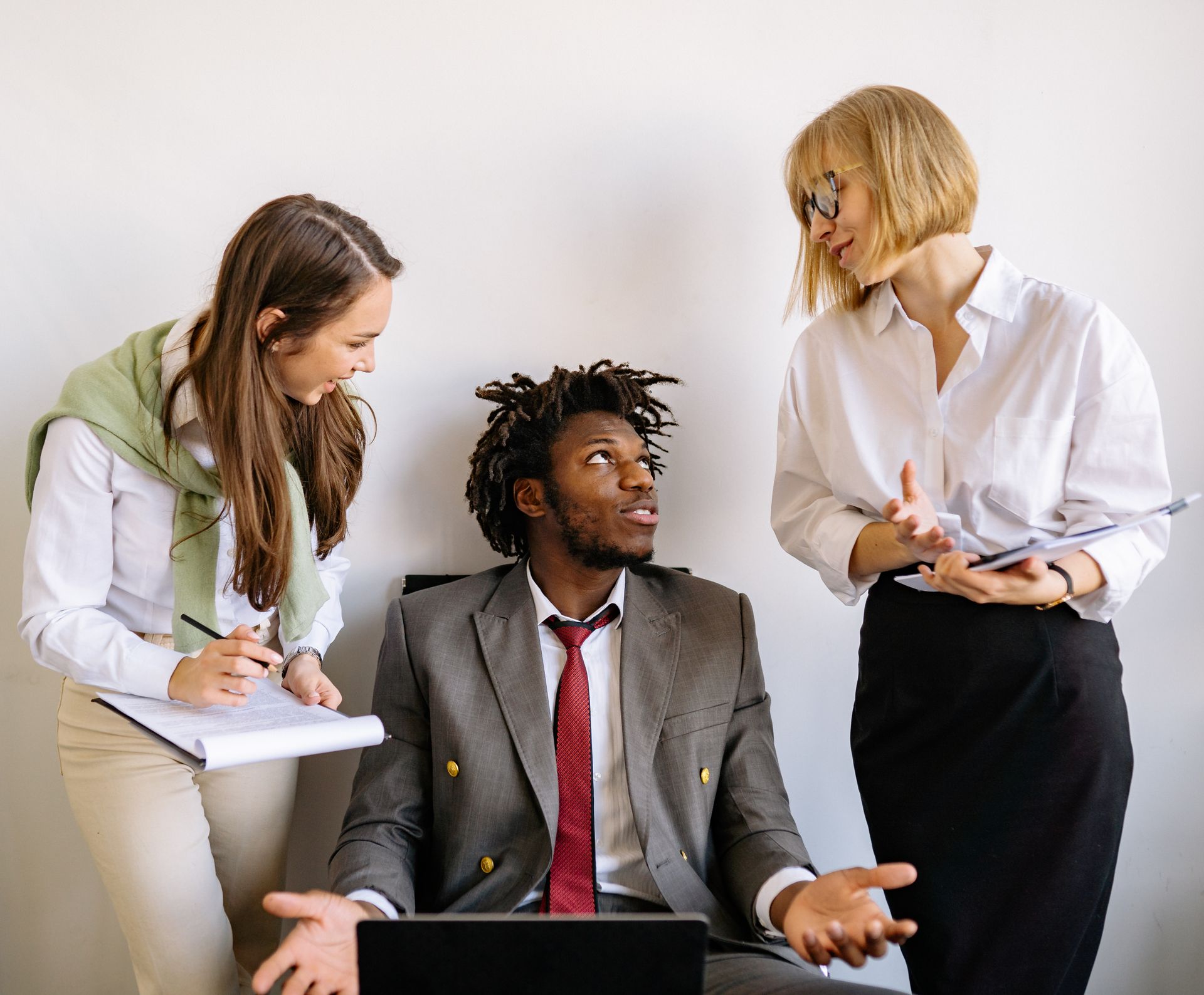 A diverse team collaborates on business strategy in a modern office setting.