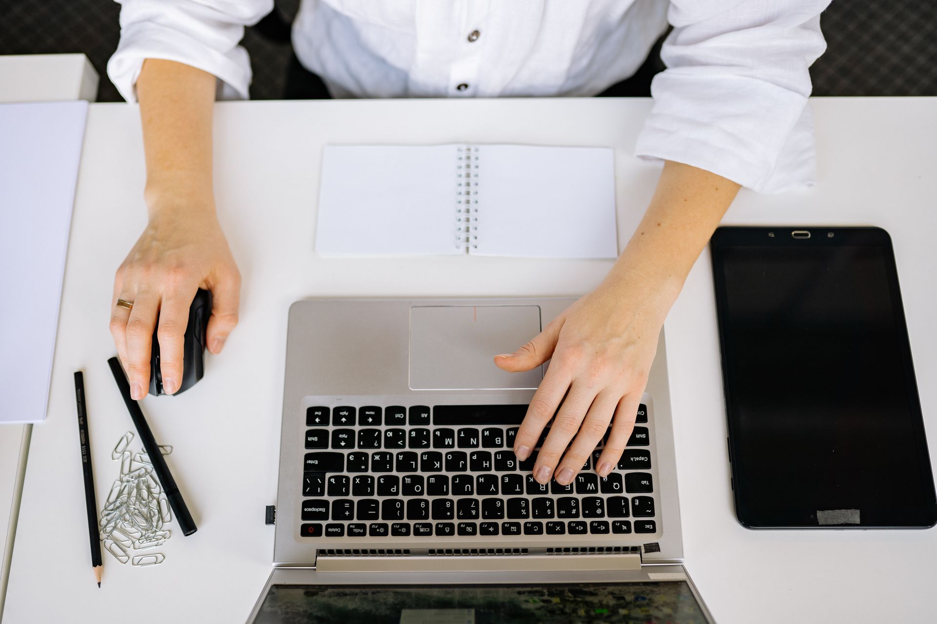 Person in White Button Up Working on His Laptop
