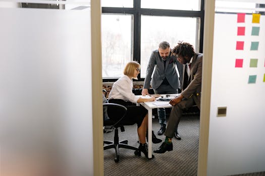 Diverse team engaged in a collaborative meeting in a modern office environment.