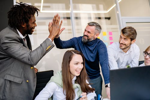 Free Men Doing High Five at the Office Stock Photo
