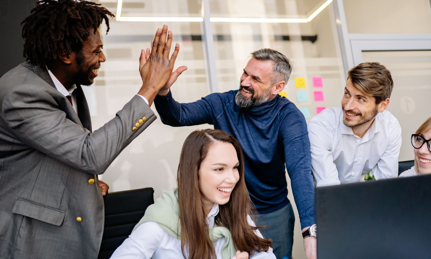 A diverse team celebrating together at work