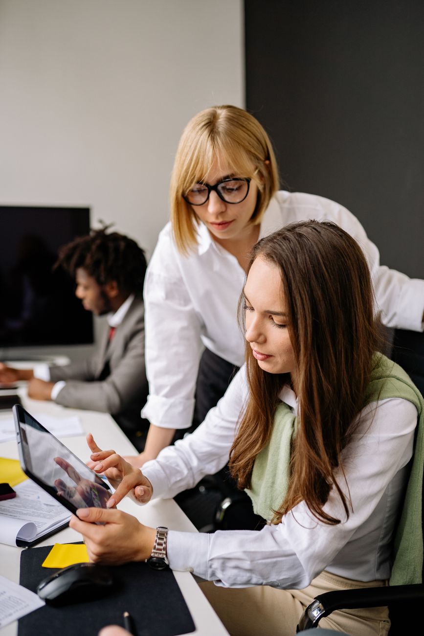 Team collaborating around a computer screen in a modern office