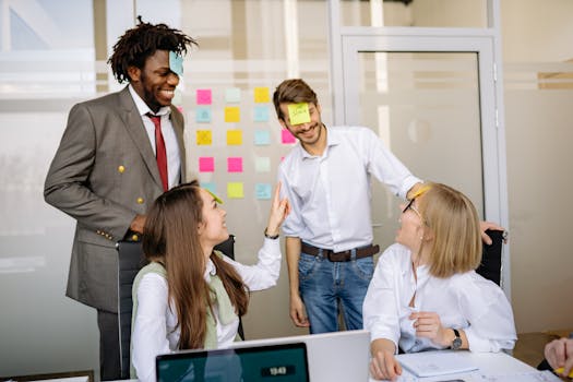 A diverse team engages in a fun brainstorming session with sticky notes and laughter.