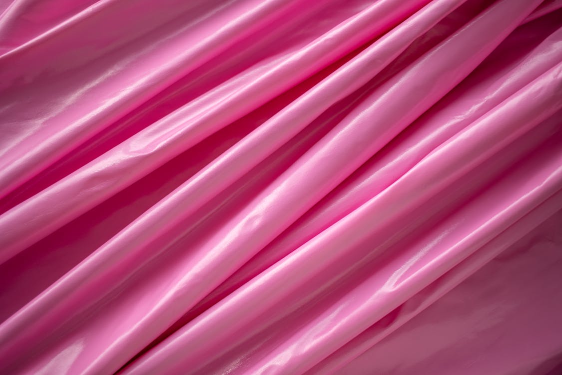 Crumpled pink fabric with wavy lines