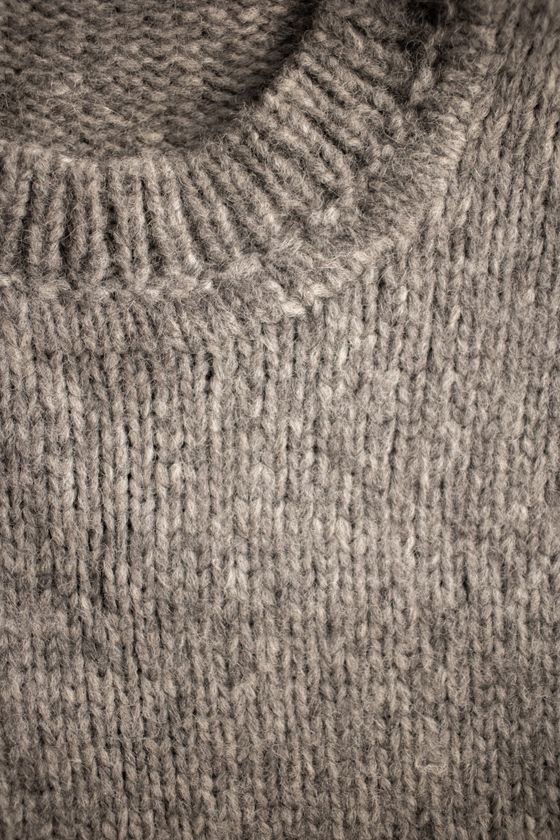 Close-up of the collar of a beige knitted sweater, photo by Monstera Production on Pexels