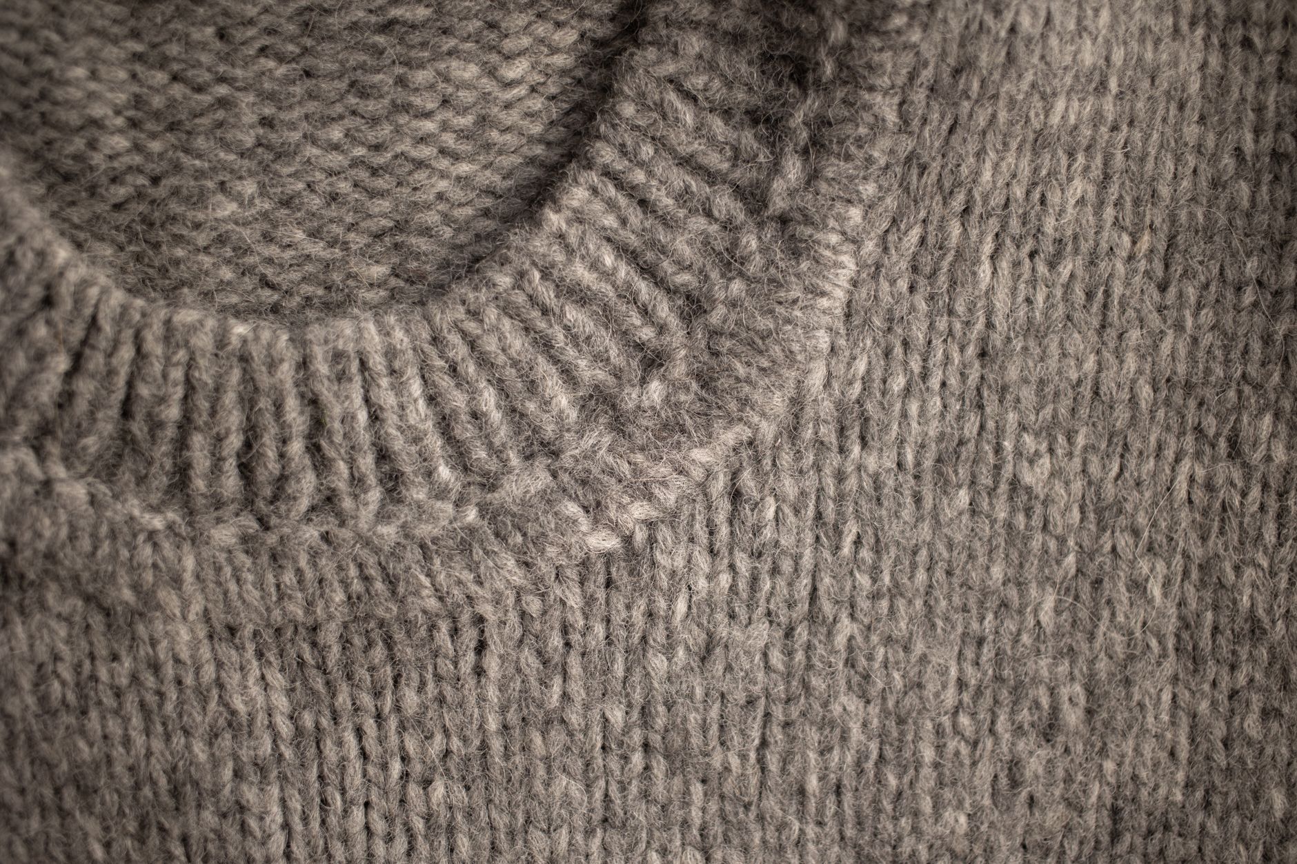 close-up of knitwear fabric showing pilling and surface fuzzing