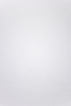 A smooth white textured background suitable for minimalistic design projects.