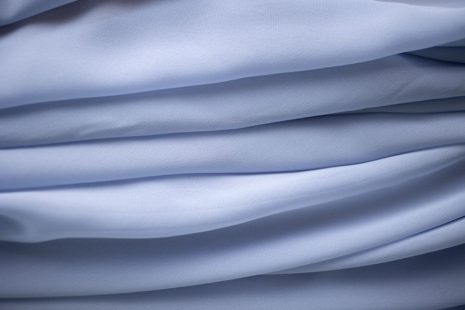 Close-up of light blue fabric folds creating a delicate flowing texture.