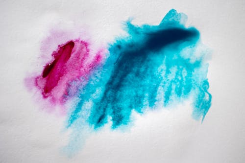 Pink and Blue Paint on White Paper