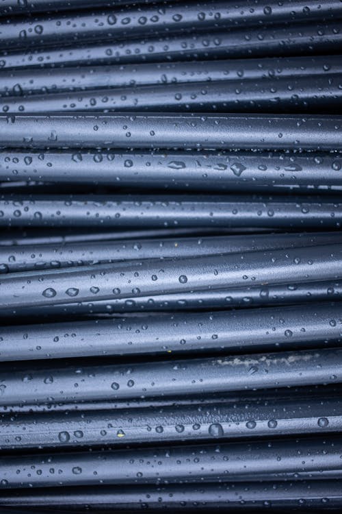 Free Glowing black rubber rods with droplets Stock Photo