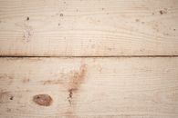 Background of textured surface of wooden boards with linear pattern and brown spots
