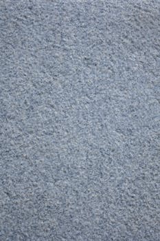 Textured backdrop representing rough rocky surface with multiple irregular gray and white dots